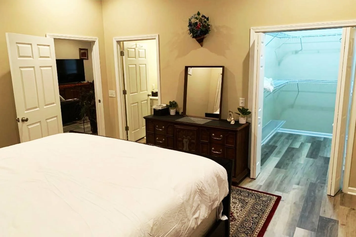 Bedroom with adjoining bathroom at Troopers Lane Getaway in Waycross, Georgia.